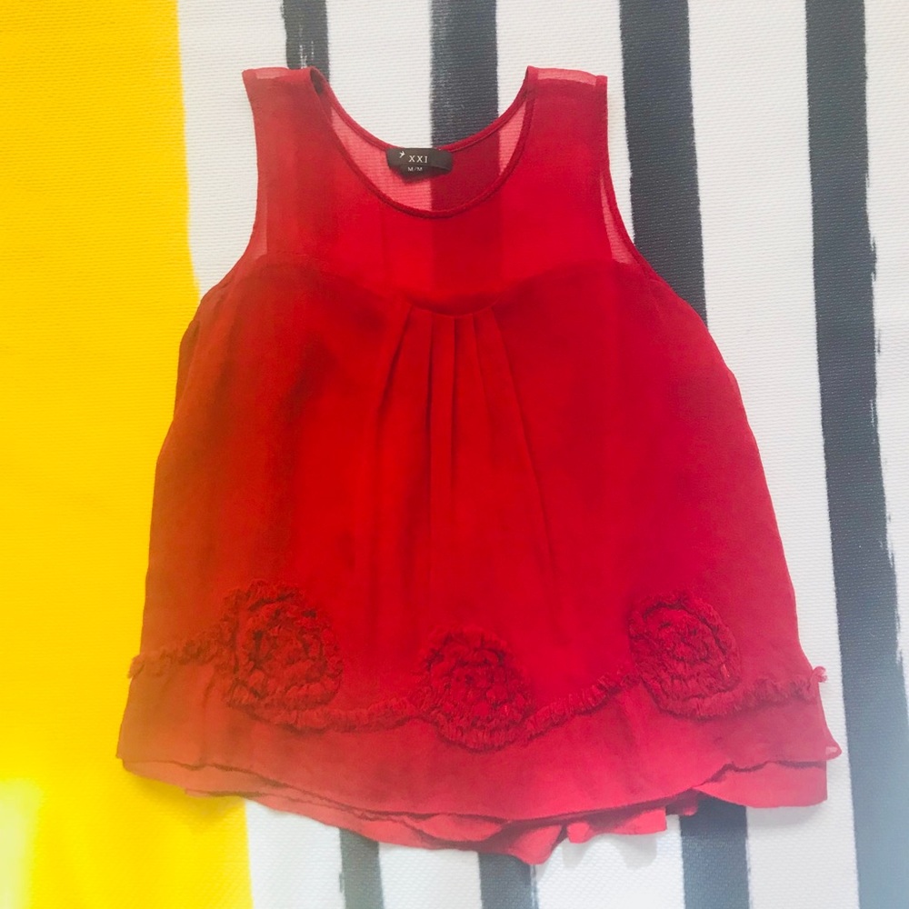 Red sleeveless blouse with flower designs